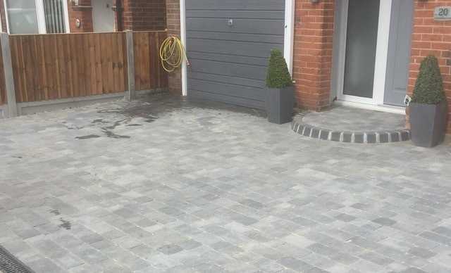 Front grey block paved door step